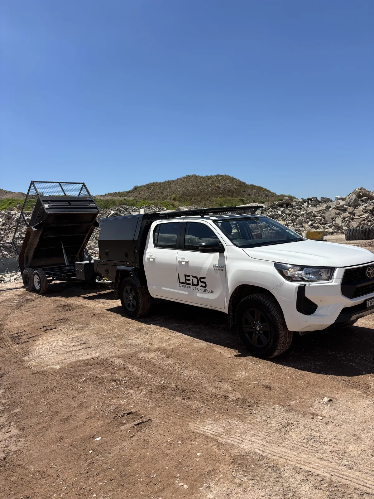 LEDS ute and tipper on a site clean-up