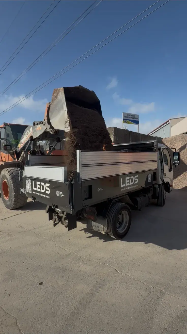 Tipper loaded with demolition waste
